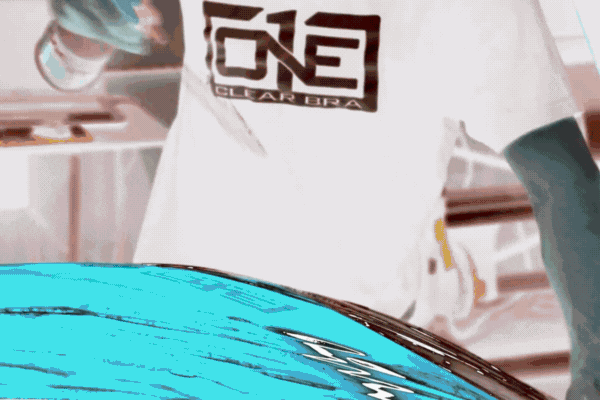 Technician applying paint protection film onto a car hood, showing the clear bra installation process and why paint protection film is essential in Colorado Springs.